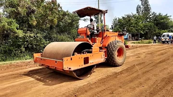Compaction of sub-base ahead of surfacing with heavy roller.